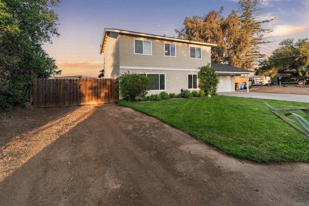 435 West Hawthorne Street Fallbrook, CA 92028 - Photo 40 of 42 a front view of a house with a yard and trees