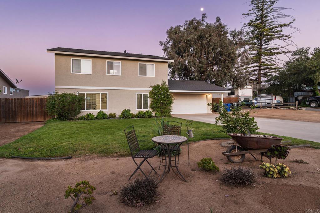 435 West Hawthorne Street Fallbrook, CA 92028 - Photo 42 of 42 a view of a backyard with table and chairs and a small yard