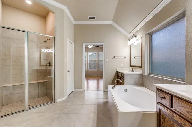 a spacious bathroom with a tub shower and sink
