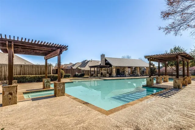 swimming pool view with a seating space