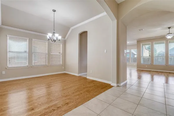 a view of an empty room with glass door and windows