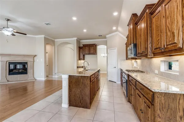 a kitchen with stainless steel appliances granite countertop a sink and cabinets
