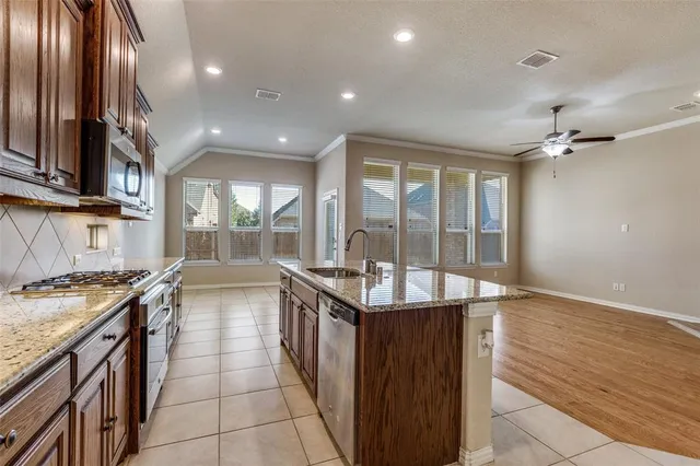 a kitchen with stainless steel appliances granite countertop a stove and a sink