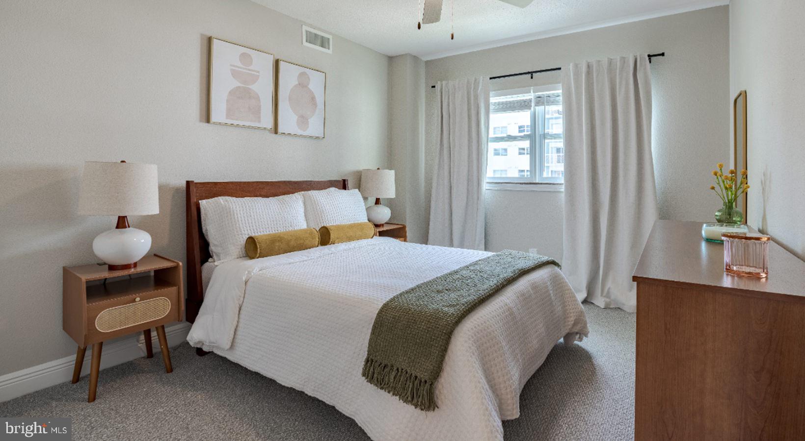 4851 Ellin Road, Unit 121 Hyattsville, MD 20784 - Photo 3 of 14 a bedroom with a bed and a potted plant on the dresser