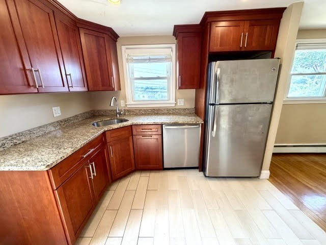 116 Upton Road Waltham, MA 02452 - Photo 6 of 22 a kitchen with stainless steel appliances granite countertop a refrigerator a sink a stove a microwave and cabinetry