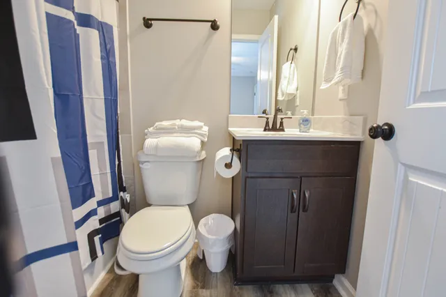 a bathroom with a toilet a sink and mirror