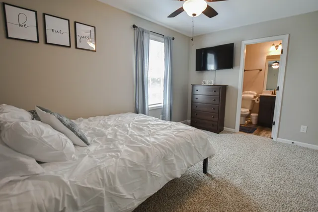 a bedroom with a bed and a flat screen tv
