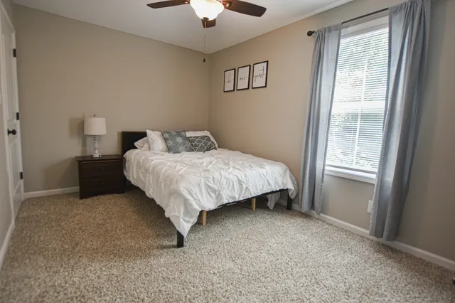 a bedroom with a bed and a window