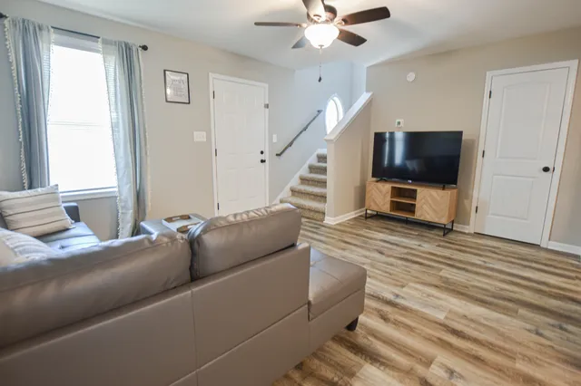 a living room with furniture and a flat screen tv