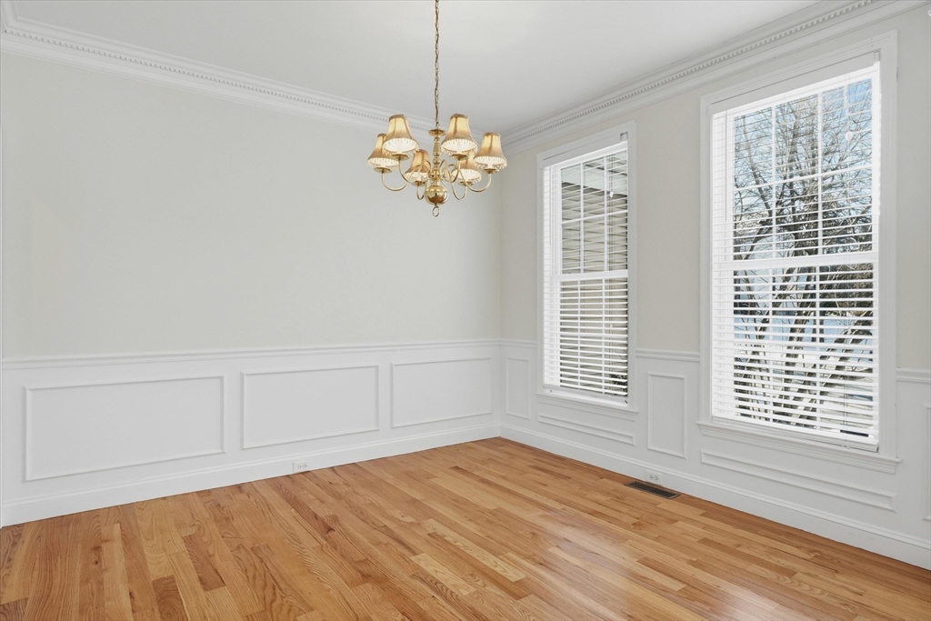 14 Amberville Road North Andover, MA 01845 - Photo 6 of 42 a view of an empty room with a window and wooden floor