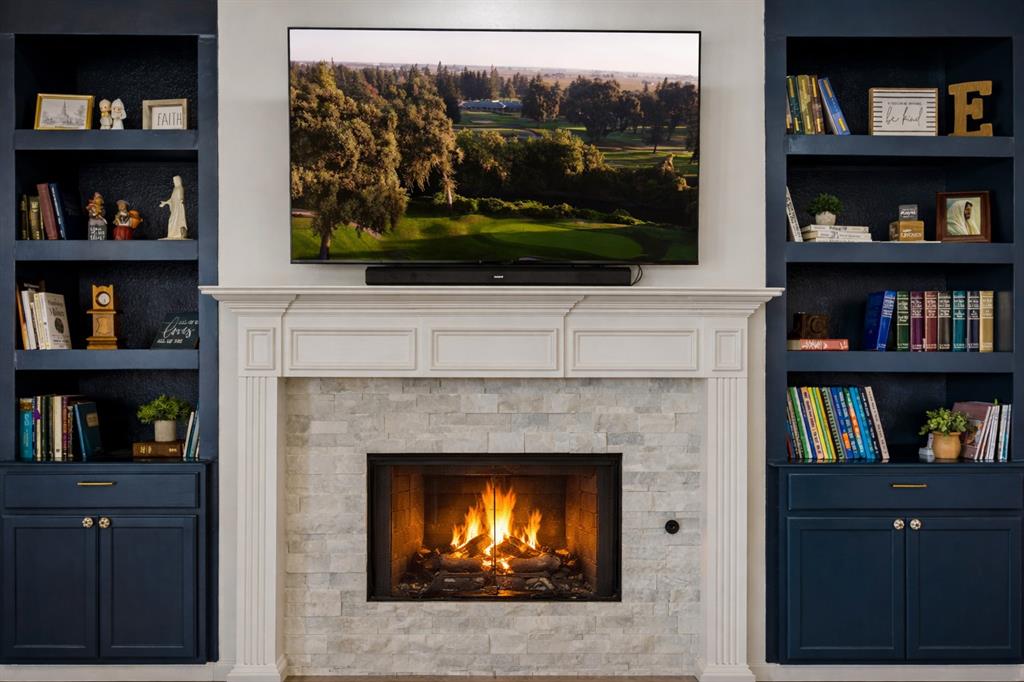 5315 Summit Knoll Trail Sachse, TX 75048 - Photo 14 of 40 a living room with a fireplace and a flat screen tv