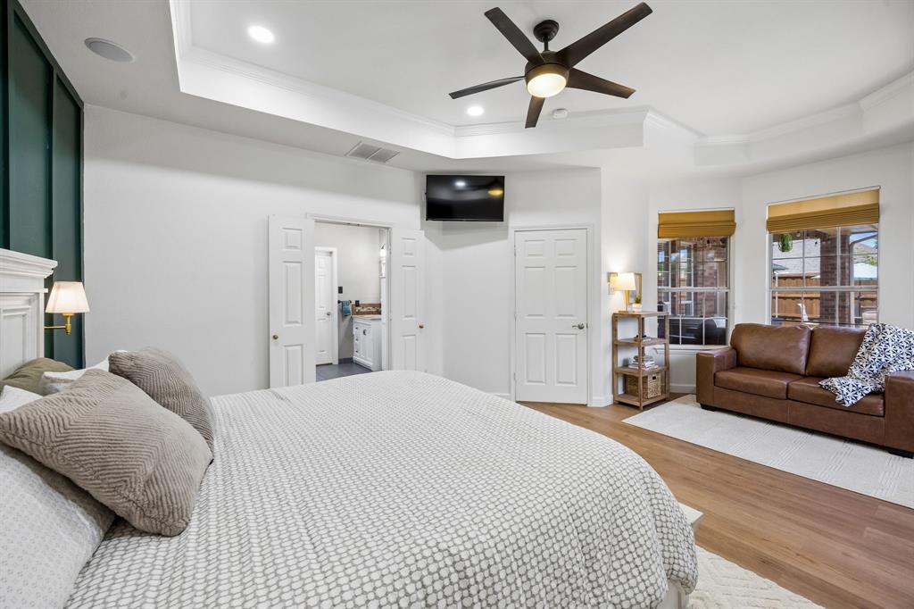 5315 Summit Knoll Trail Sachse, TX 75048 - Photo 18 of 40 a spacious bedroom with a bed a couch and a large window