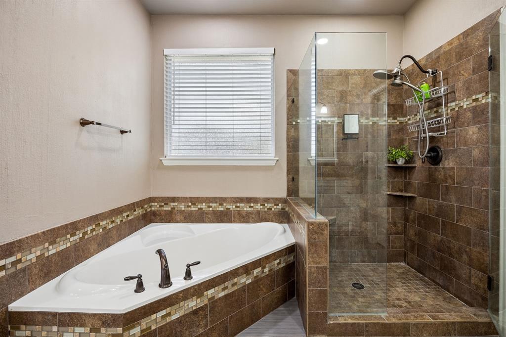 5315 Summit Knoll Trail Sachse, TX 75048 - Photo 22 of 40 a bathroom with a tub and a shower