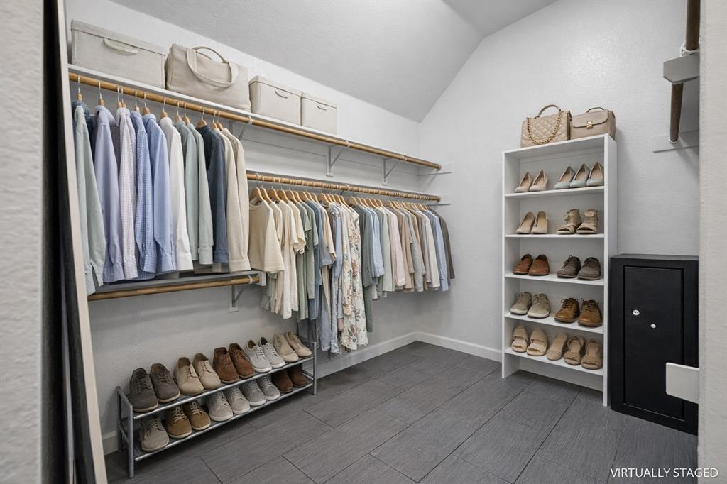 5315 Summit Knoll Trail Sachse, TX 75048 - Photo 23 of 40 a view of walk in closet with clothes and shoes