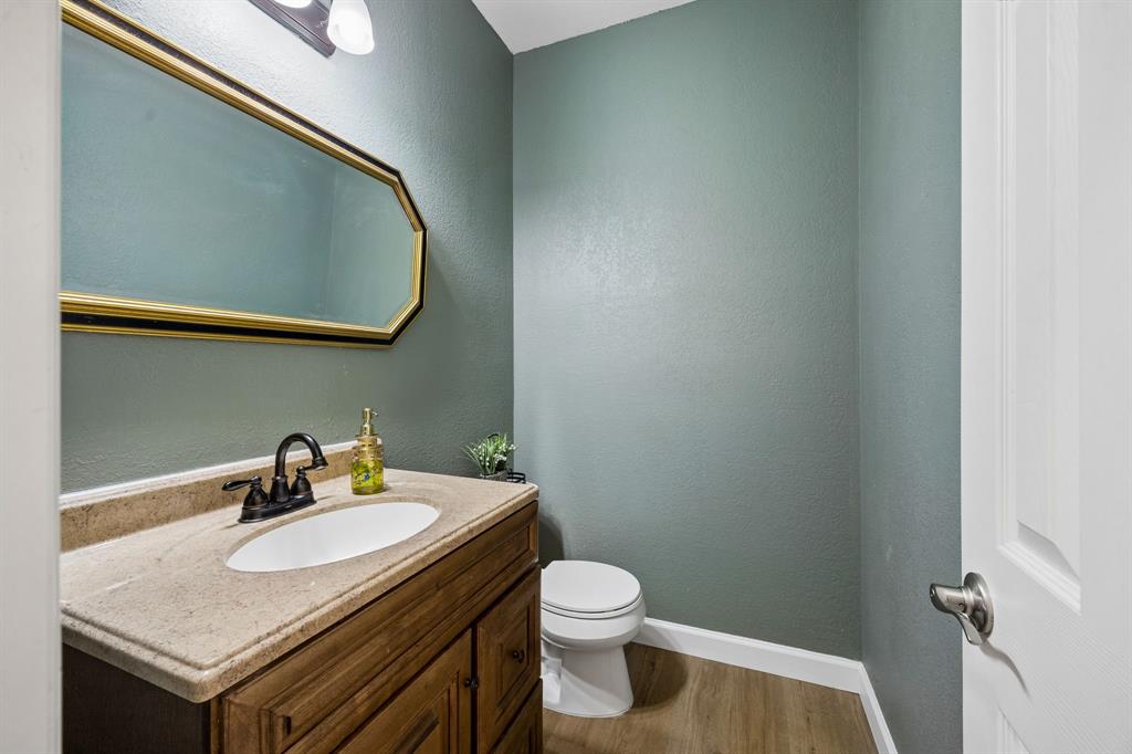 5315 Summit Knoll Trail Sachse, TX 75048 - Photo 24 of 40 a bathroom with a granite countertop sink and a mirror