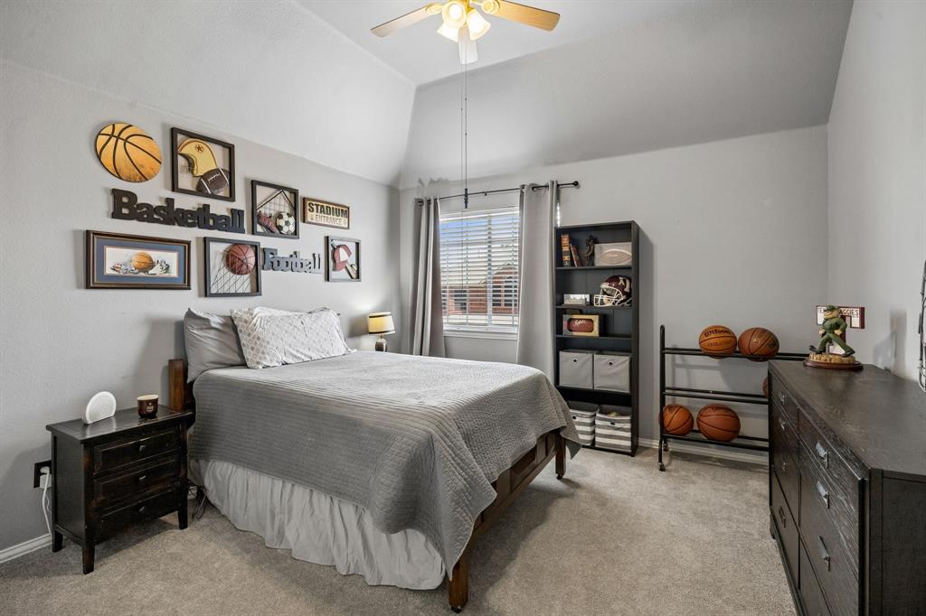 5315 Summit Knoll Trail Sachse, TX 75048 - Photo 27 of 40 a bedroom with a bed and a chandelier