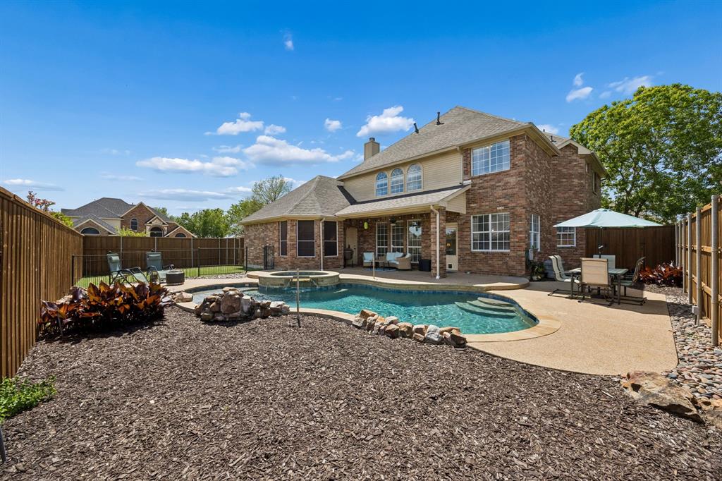 5315 Summit Knoll Trail Sachse, TX 75048 - Photo 32 of 40 a view of a house with backyard and sitting area