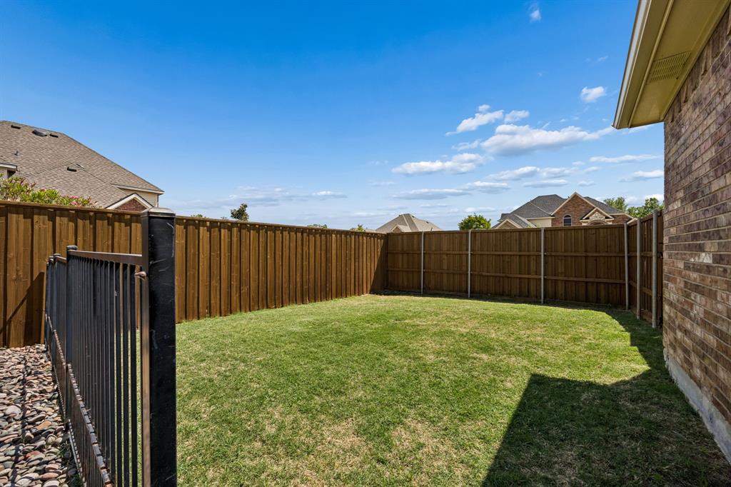 5315 Summit Knoll Trail Sachse, TX 75048 - Photo 34 of 40 a view of a backyard with wooden fence