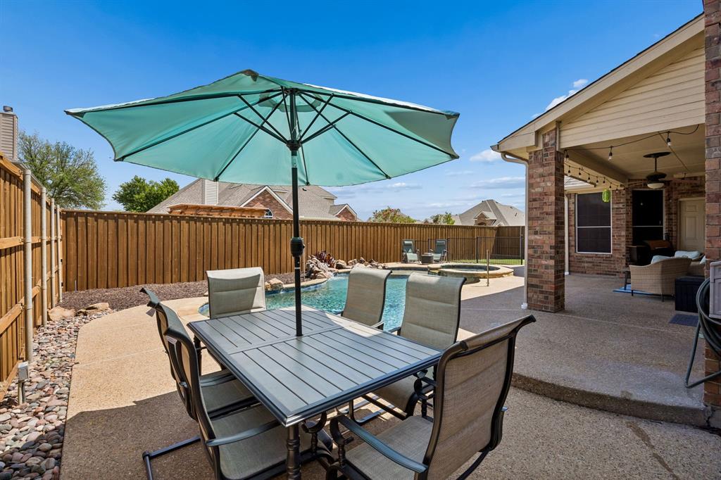 5315 Summit Knoll Trail Sachse, TX 75048 - Photo 36 of 40 a view of an outdoor sitting area with furniture and umbrella