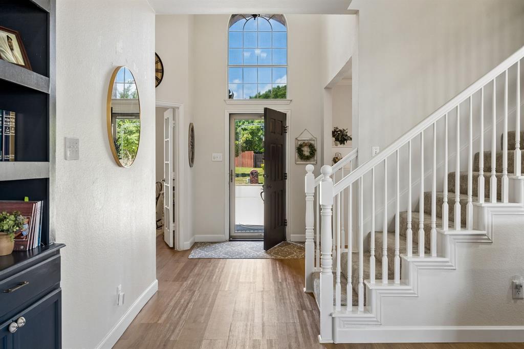 5315 Summit Knoll Trail Sachse, TX 75048 - Photo 5 of 40 a view of a hallway view with wooden floor and staircase