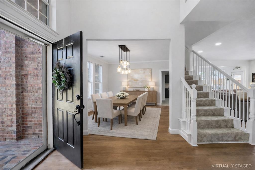 5315 Summit Knoll Trail Sachse, TX 75048 - Photo 6 of 40 a view of a dining room with furniture a chandelier and wooden floor