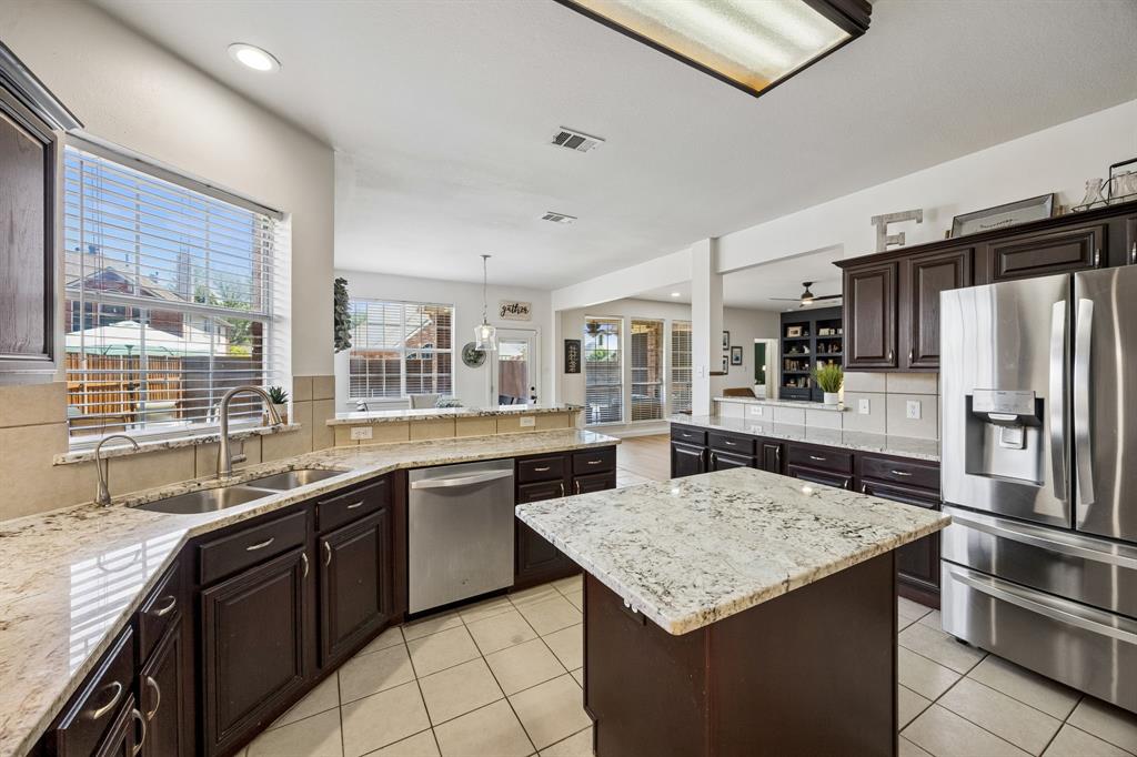 5315 Summit Knoll Trail Sachse, TX 75048 - Photo 10 of 40 a kitchen with stainless steel appliances granite countertop a sink stove and refrigerator