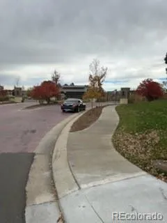 a terrace with outdoor seating and trees