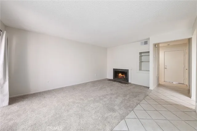 a view of an empty room with a fireplace