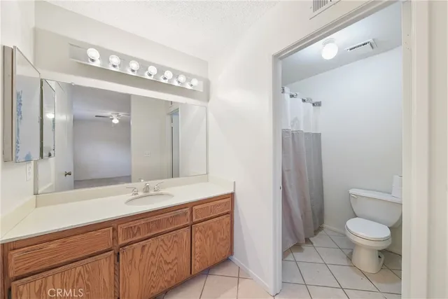 an empty room with a ceiling fan and window