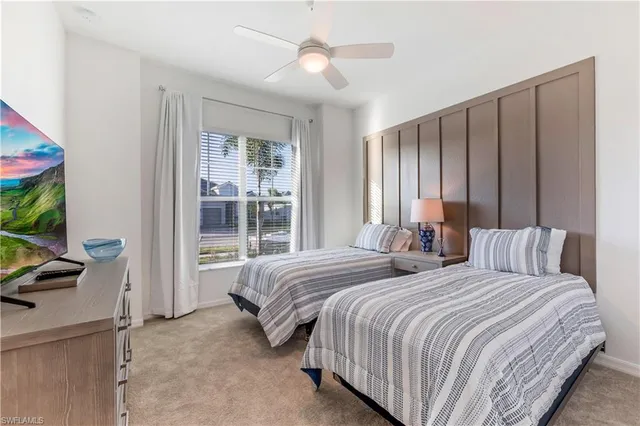 a bedroom with a bed and large windows