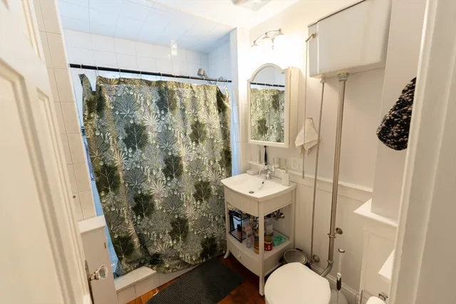 a bedroom with a bed closet and a window