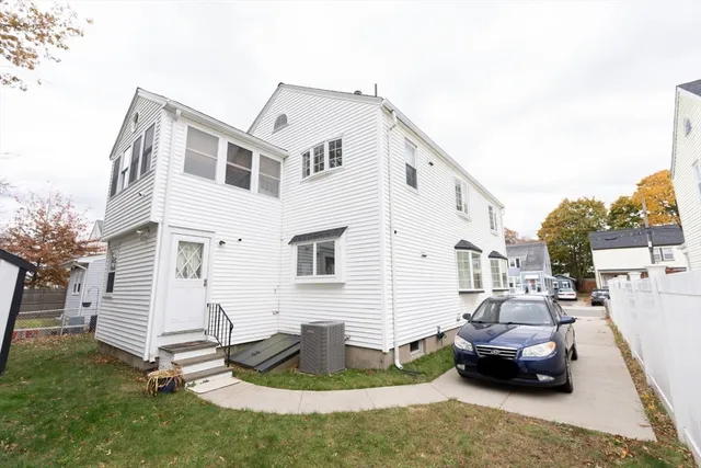 a view of a house with backyard and sitting area