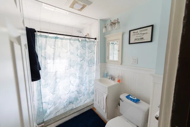 a bathroom with a shower toilet and sink