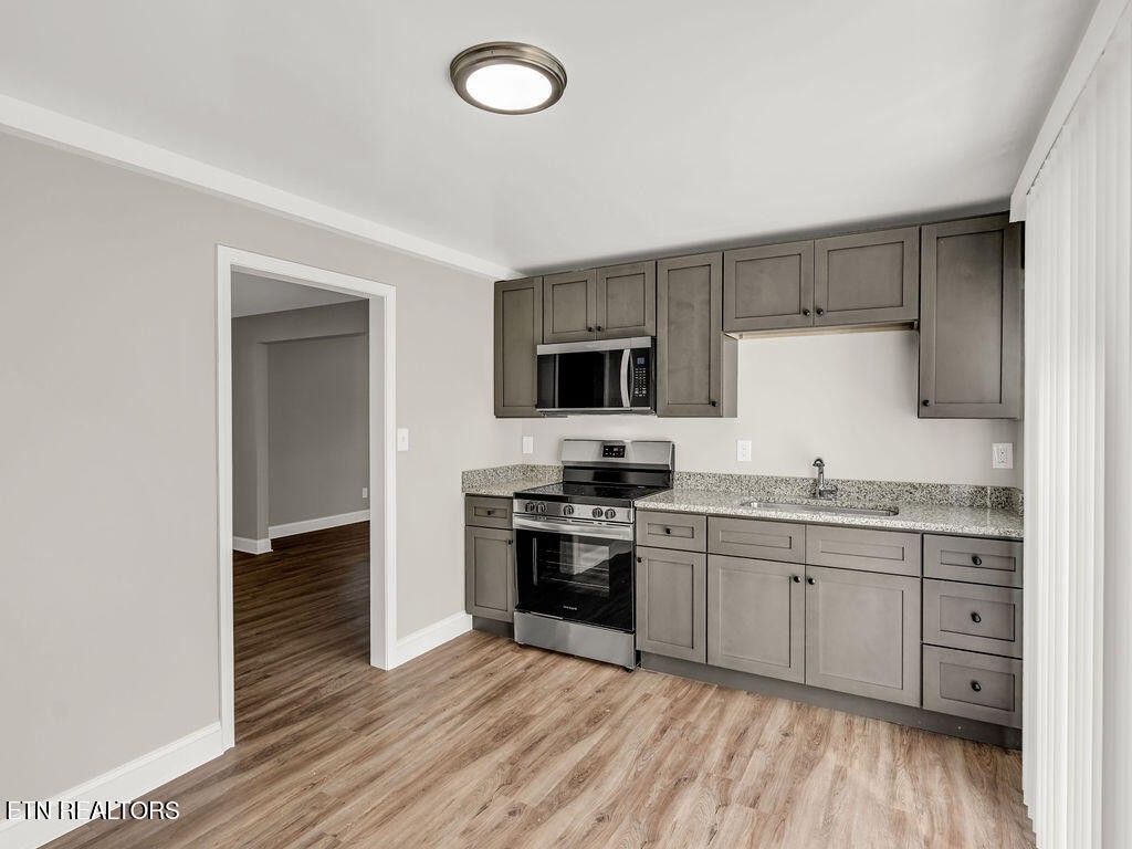 155 Tacoma Road Oak Ridge, TN 37830 - Photo 16 of 33 a kitchen with stainless steel appliances granite countertop a stove and a sink