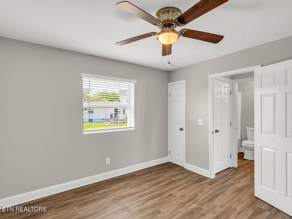 155 Tacoma Road Oak Ridge, TN 37830 - Photo 21 of 33 a view of an empty room with a window and a ceiling fan