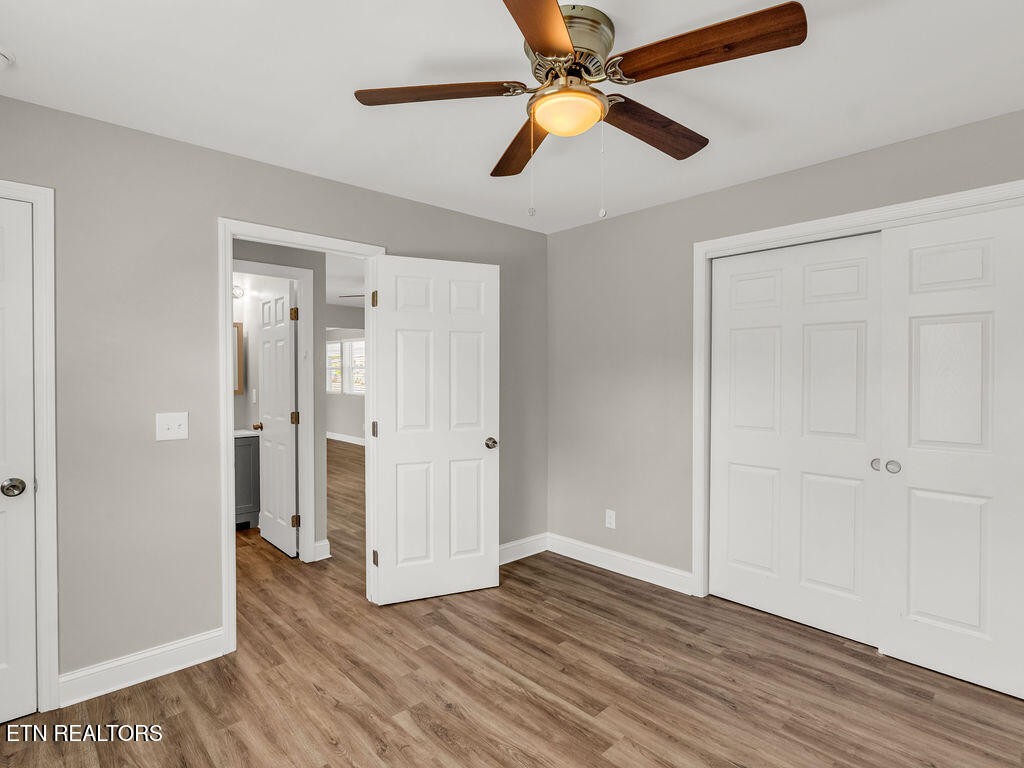155 Tacoma Road Oak Ridge, TN 37830 - Photo 22 of 33 an empty room with wooden floor a ceiling fan and closet