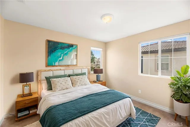 a bedroom with a bed and a potted plant