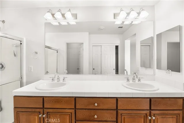 a bathroom with a sink vanity and a mirror