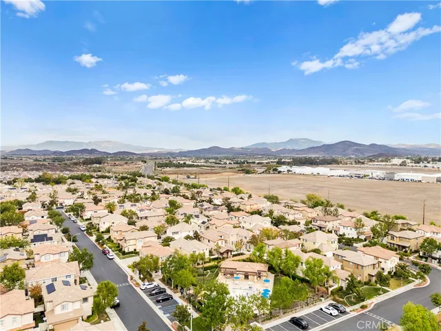 an aerial view of a swimming pool with outdoor seating and yard