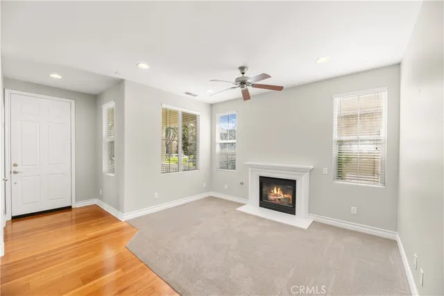 a view of an empty room with a fireplace and a window
