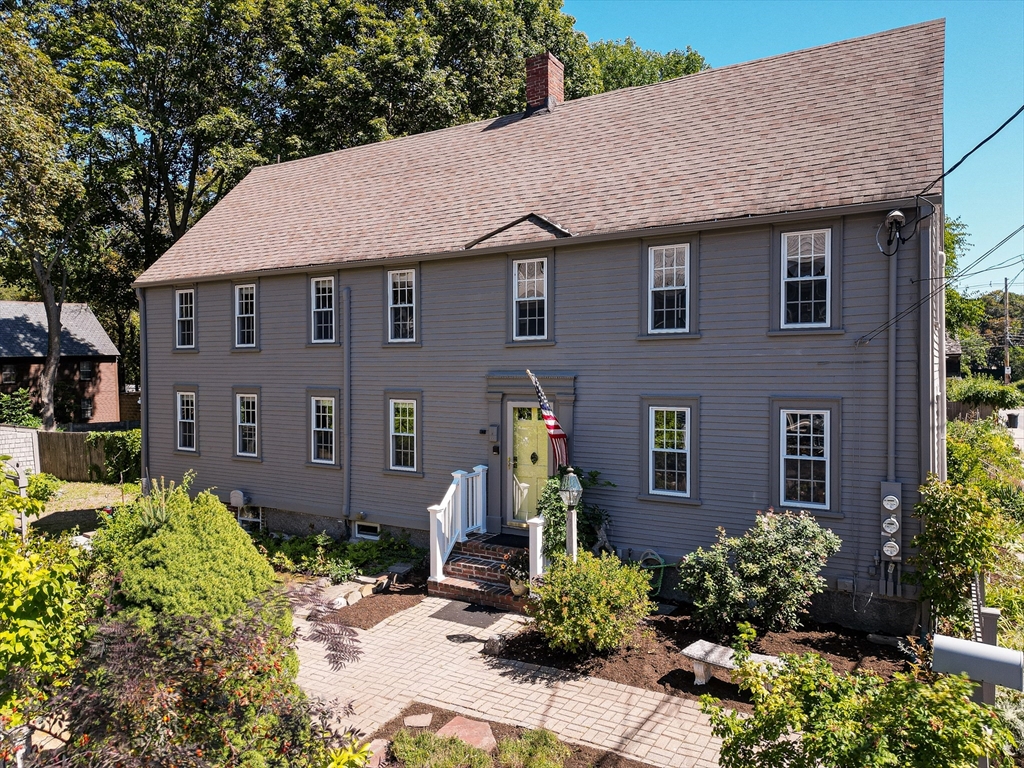 a aerial view of a brick house next to a yard