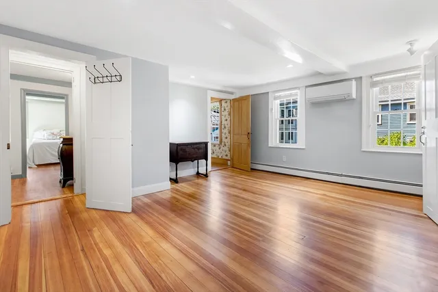 a view of empty room with wooden floor