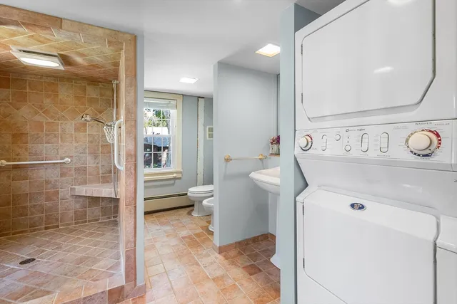 a bathroom with a sink a mirror and next to a window