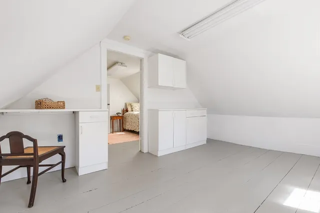 a view of a livingroom with a staircase and white walls