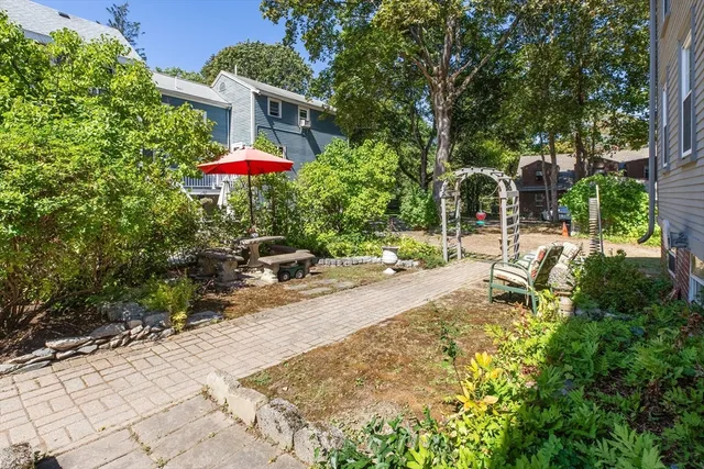 an aerial view of a house with a garden and lake view
