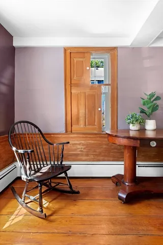 a view of a livingroom with furniture and hardwood floor