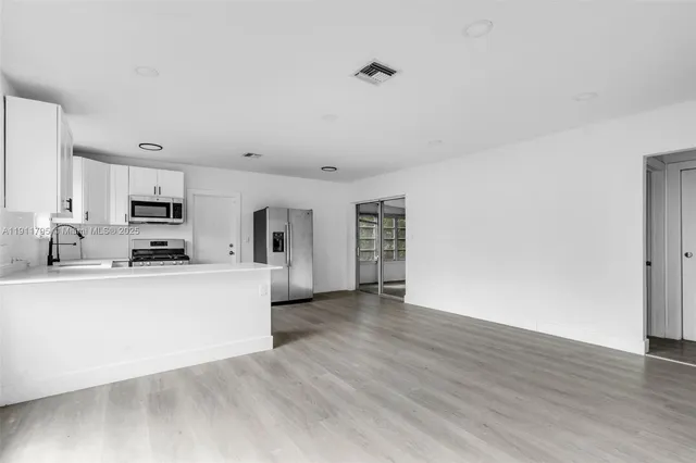 a view of kitchen with wooden floor