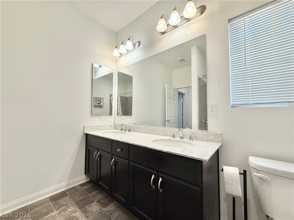 7777 South Westwind Road Las Vegas, NV 89139 - Photo 16 of 46 Double vanity with stone counters provides ample space and elegant design.