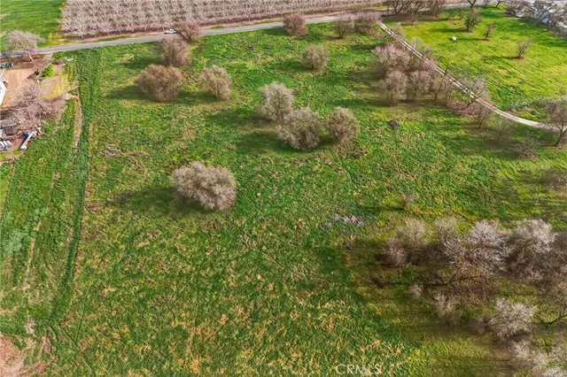 a aerial view of a house with a yard and a water fountain