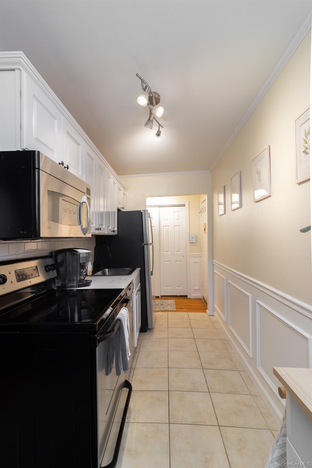 2449 Union Boulevard, Unit 36A Islip, NY 11751 - Photo 5 of 15 a kitchen with kitchen island granite countertop a sink appliances and cabinets